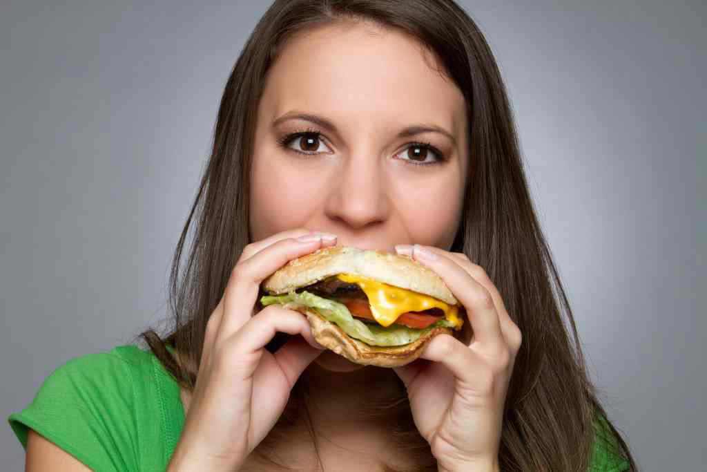 Beautiful girl eating hamburger food